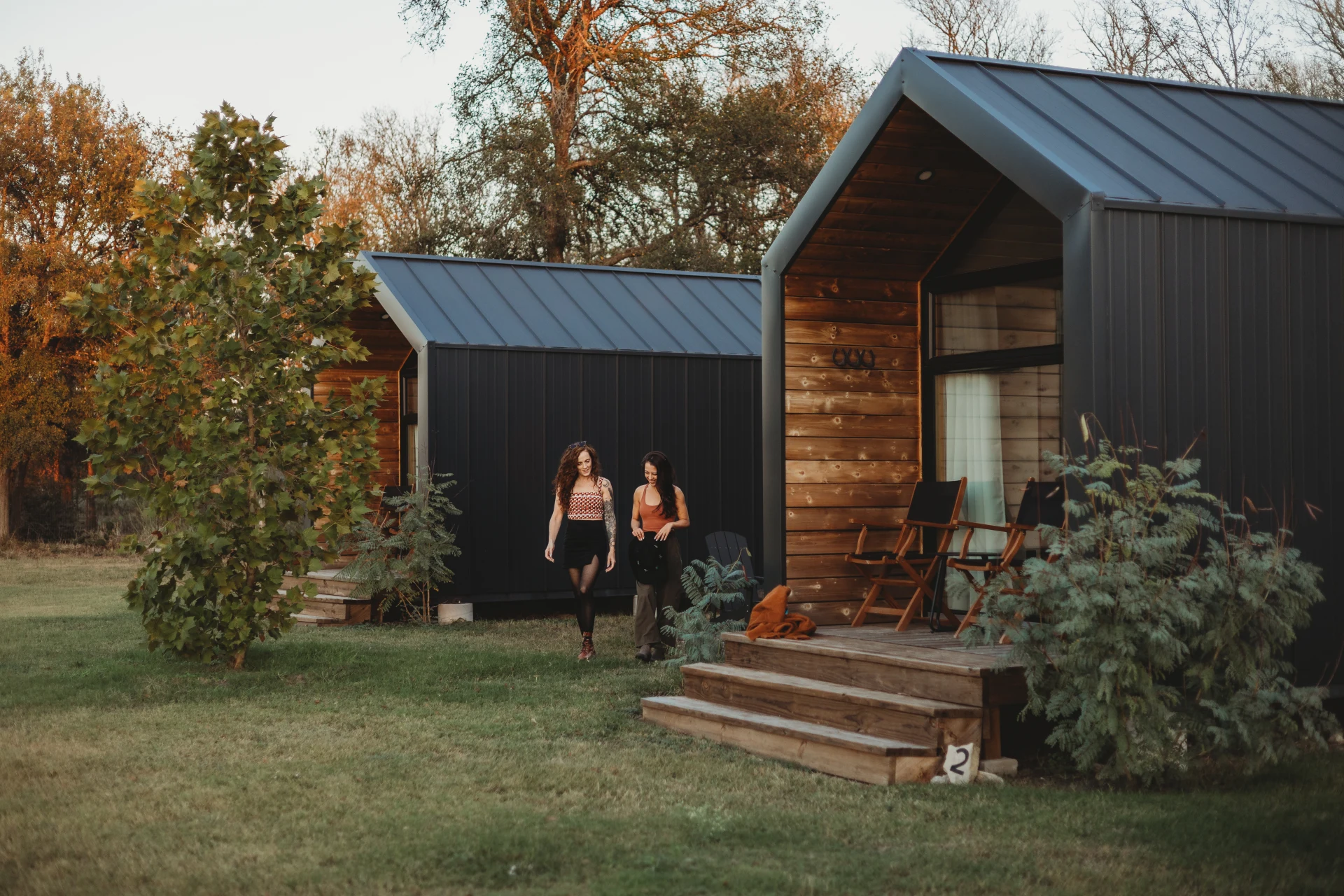 Hand-crafted cabin with covered porch and floor-to-ceiling windows at Rancho Moonrise glamping near Austin