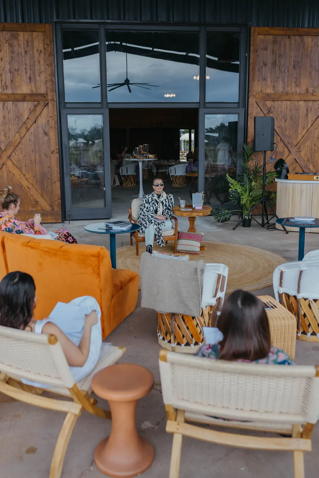 Guests relaxing on the event barn patio at Rancho Moonrise