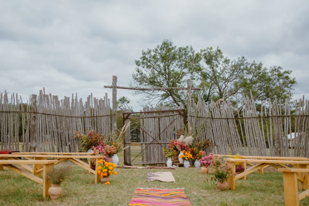 Wedding ceremony in the horse corral at Rancho Moonrise with guests seated under the Texas sky